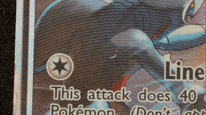 A close-up inspection of a trading card surface defect